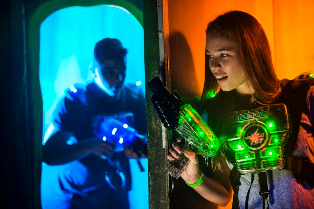 Lasertag-Spielerin mit Weste und Phaser